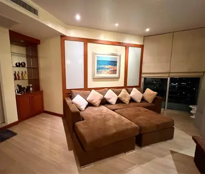 a living room with a brown couch with pillows at Riverside room with best view in heart of BKK in Godown