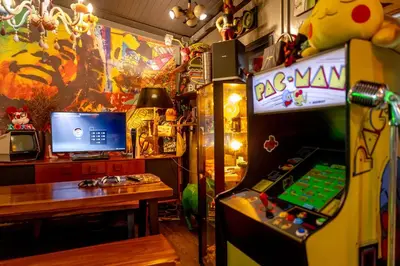 a room with a desk and a video game machine at Vibes Hostel Bangkok in Bangkok