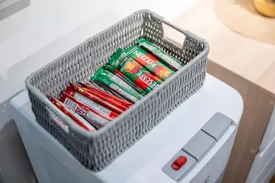 a basket on top of a cooler filled with toothbrushes at Vibes Hostel Bangkok in Bangkok