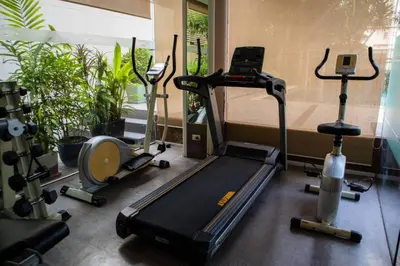 a gym with several exercise bikes and a treadmill at Shine Sukhumvit 33 Aparthotel Phrompong in Bangkok