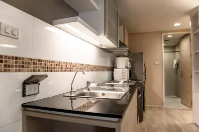 a kitchen with a sink and a counter top at Shine Sukhumvit 33 Aparthotel Phrompong in Bangkok