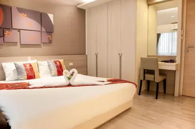 a bedroom with a bed with a teddy bear on it at Shine Sukhumvit 33 Aparthotel Phrompong in Bangkok