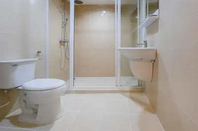 a bathroom with a toilet and a shower at GP House Express Sukhumvit 81 in Bangkok