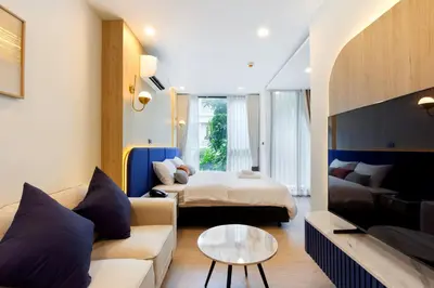 a hotel room with a bed and a couch at Aquila Hotel Bangkok in Bangkok