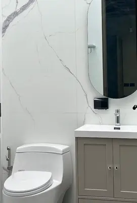 a bathroom with a toilet and a sink and a mirror at Brown Brick Thonglor - Green Greenery Room in Bangkok