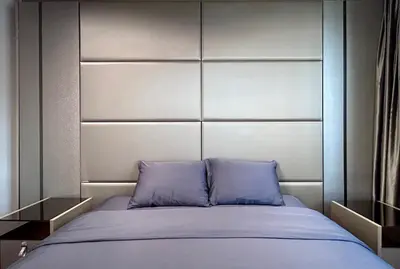 a bed with two blue pillows in a bedroom at Brown Brick Thonglor - Green Greenery Room in Bangkok