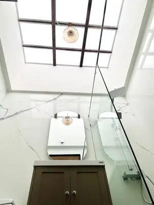 a room with a ceiling with skylights and a table at Brown Brick Thonglor - Green Greenery Room in Bangkok