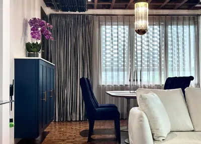 a living room with a white couch and a table at Brown Brick Thonglor - Green Greenery Room in Bangkok