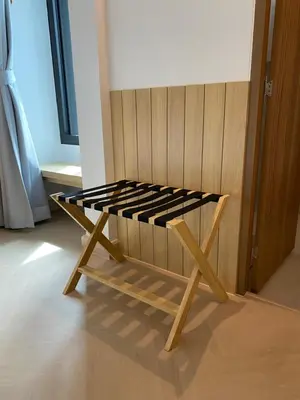 a wooden bench sitting in the corner of a room at THE CELESTRAIL - Apartment - Check-In by Appointment Only - Non-hotel - Onnut BTS in Bangkok