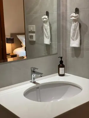 a bathroom sink with a mirror and a soap dispenser at THE CELESTRAIL - Apartment - Check-In by Appointment Only - Non-hotel - Onnut BTS in Bangkok
