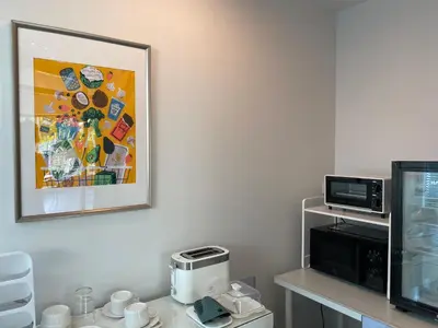 a kitchen with a microwave and a picture on the wall at THE CELESTRAIL - Apartment - Check-In by Appointment Only - Non-hotel - Onnut BTS in Bangkok
