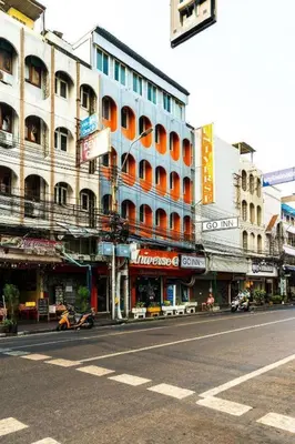 a city street with a large building on the side of the road at XX GO INN Khaosan The Grand Palace Bangkok in Bangkok