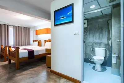 a hotel room with a bed and a toilet at XX GO INN Khaosan The Grand Palace Bangkok in Bangkok