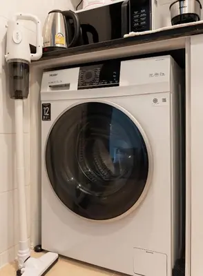 a microwave sitting on top of a washing machine at Artichoke Suite Sukhumvit, Nana BTS in Bangkok