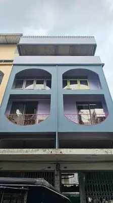 a blue building with three windows on it at Private apartment at Sukhumvit67 Penthouse Unit in Bangkok