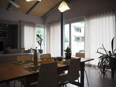 a dining room with a table with chairs and a couch at Private apartment at Sukhumvit67 Penthouse Unit in Bangkok