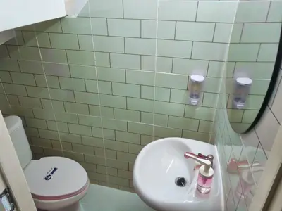 a bathroom with a sink and a toilet at Haus Sathorn Pier 2 Cozy Bedroom City Center in Bangkok