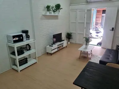 a living room with a tv and a couch at Haus Sathorn Pier 2 Cozy Bedroom City Center in Bangkok