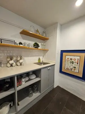 a kitchen with a sink and a counter top at Seen Hostel Bangkok The Riverwalk in Bangkok