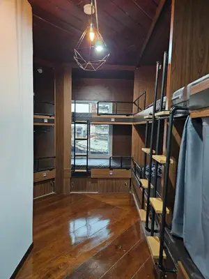 a room with two bunk beds and a window at Seen Hostel Bangkok The Riverwalk in Bangkok