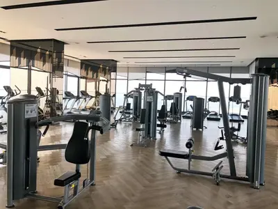 a gym with several treadmills and machines in it at Sky & River side view bts condo in Ban Sai Ma