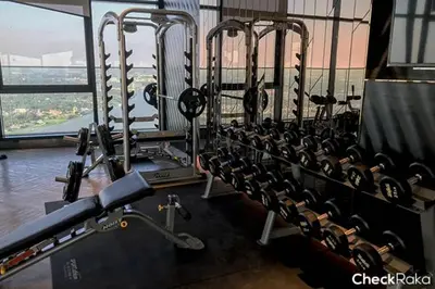 a gym with a row of cardio machines at Sky & River side view bts condo in Ban Sai Ma