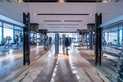 a gym with treadmills and machines in a building at Sky & River side view bts condo in Ban Sai Ma