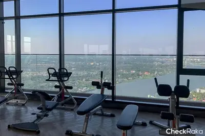 a gym with a large window with chairs in it at Sky & River side view bts condo in Ban Sai Ma