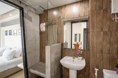 a bathroom with a sink and a shower and a toilet at Baron Zotel Bangkok SHA PLUS in Bangkok