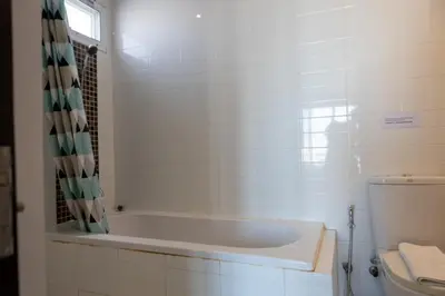 a white bath tub in a bathroom with a toilet at P Villa Lamoon Thonglor in Bangkok