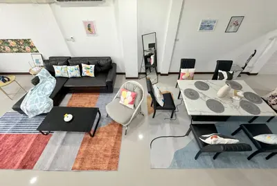 a living room with a couch and a table at MIQ HK611 Huai Khwang 4BR Jodd fair in Bangkok