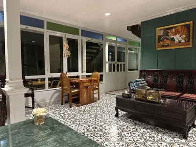 a living room with a couch and a table at Baan Debtida in Bangkok