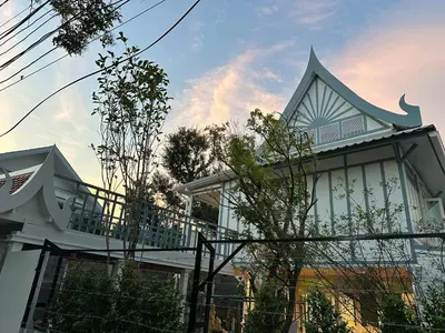 a house with a fence in front of it at Baan Debtida in Bangkok