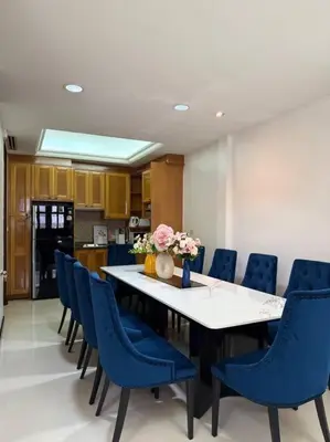 a dining room with a table and blue chairs at Miq Asoke 5BR Sukhuvit15 in Makkasan