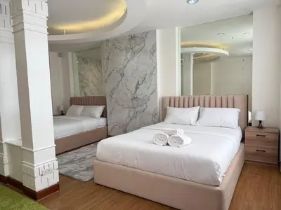 a bedroom with two beds with plates on them at Miq Asoke 5BR Sukhuvit15 in Makkasan