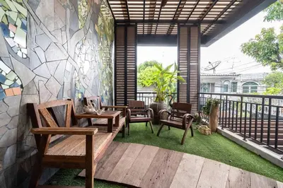 a patio with chairs and tables on a balcony at MIQ Rama9 Villa 3Br in City Jodd fair MRT in Makkasan