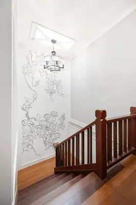 a staircase with a wall with a drawing on the wall at MIQ Rama9 Villa 3Br in City Jodd fair MRT in Makkasan