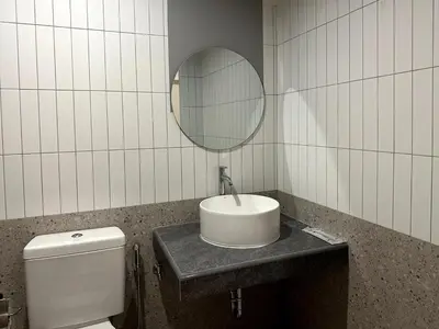 a bathroom with a sink and a mirror and a toilet at Lune bangkok in Bangna