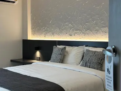 a bedroom with a large bed with white sheets and pillows at Lune bangkok in Bangna