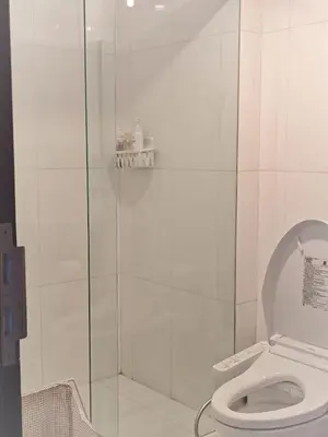 a bathroom with a toilet and a glass shower at City comfort appartment, Skytain Step 600 m, Erawan shrine in Bang Kapi