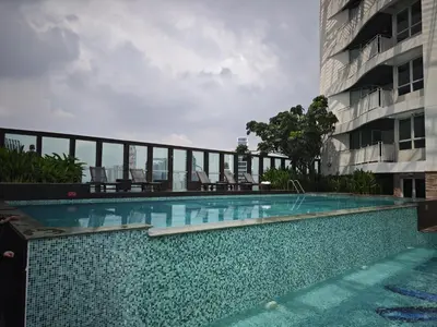 a swimming pool in front of a building at City comfort appartment, Skytain Step 600 m, Erawan shrine in Bang Kapi