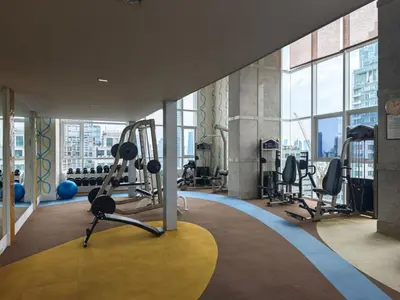 a gym with treadmills and exercise equipment in a building at City comfort appartment, Skytain Step 600 m, Erawan shrine in Bang Kapi