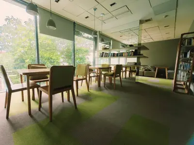 a dining room with tables and chairs in a library at Close to onnut bts condo in Bangkok