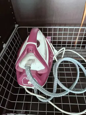 a pink and white hair dryer on a shelf at Close to onnut bts condo in Bangkok
