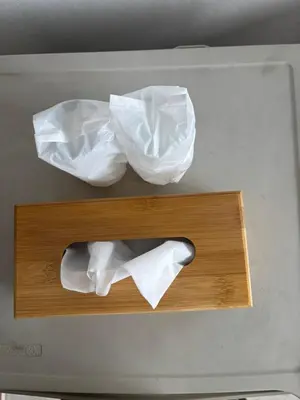 two white paper bags sitting on a wooden shelf at Ther Bangkoknoi Hotel in Bangkok Noi