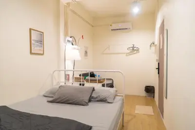 a hospital room with a bed and a lamp at Round The Clock Hostel in Samphanthawong