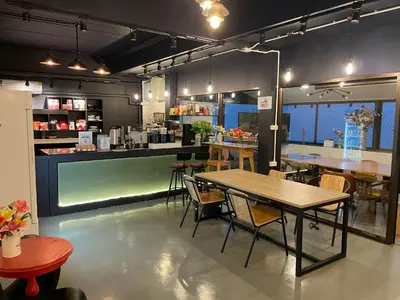 a restaurant with a table and chairs and a counter at Choose me guesthouse in Bang Kruai