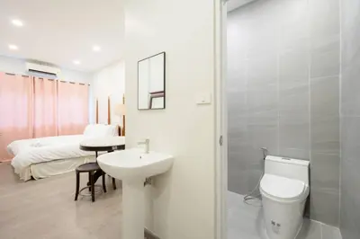 a bathroom with a sink and a toilet and a bed at XX Hidden Dragon ChinaTown MRT Wat Mangkon Station in Samphanthawong