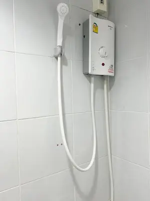 a bathroom with a white phone on the wall at Vonden Garden by Merry V in Bangkok