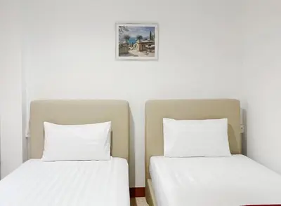 two beds sitting next to each other in a room at Vonden Garden by Merry V in Bangkok